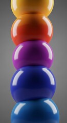 Stack of vibrant, glossy spheres with striking color contrasts on grey