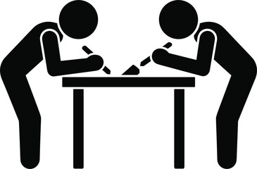 Two people writing at a table with pens and paper desk