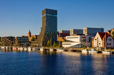 cityscape of the new harbor promenade in the danish city of Sonderborg with blue sky and evening...