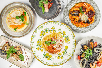 Top view of assorted Italian gourmet dishes including spaghetti with tomato sauce, seafood risotto, black pasta with shrimp and mussels, eggplant rolls, and breaded chicken cutlet