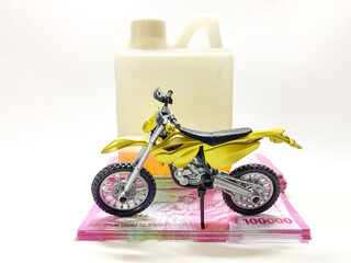 Expensive Gasoline Concept A Yellow Toy Motorcycle on Stacked Banknotes Near a Fuel Can