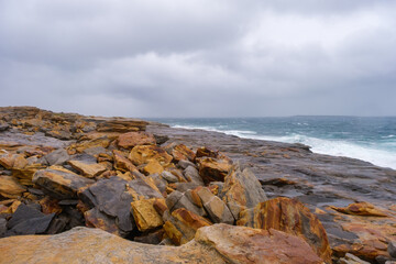 Russia, Murmansk Oblast, Rybachy Peninsula. Barents Sea coast, Orange Rocks Coast. August 2025