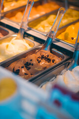 Vibrant and appetizing display of various Italian gelato flavors in a traditional ice cream parlor, showcasing rich textures and tempting colors in a close-up view.