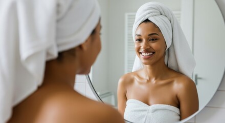 Joyful Woman with Dewy Skin in a Fluffy Towel, Smiling into a Round Mirror in a Serene, Softly Lit Bathroom