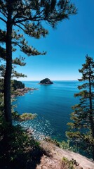 Coastal view with trees framing a small island in a blue sea. Sunny day