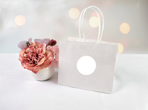 Sticker Mock Up on Gift Bag With Flowers and Lights