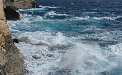 Deep blue sea with rolling waves and foamy crests, capturing the motion of the open ocean.