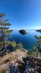 Coastal view with island, trees, blue water, clear sky