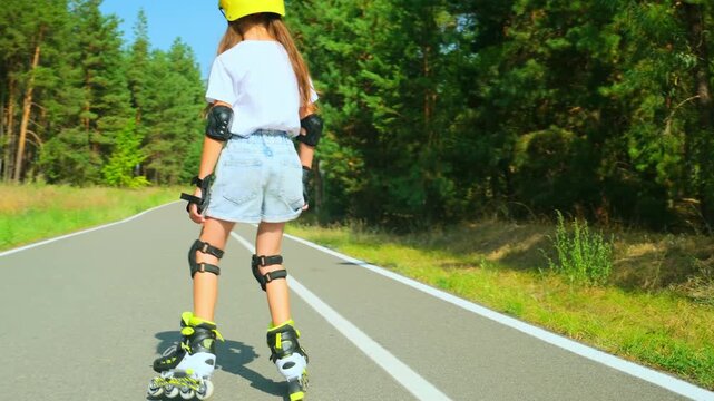 Girl is roller skating by forest, enjoying an active hobby in the open air.