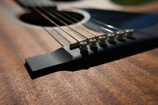 Close up picture of guitar bridge