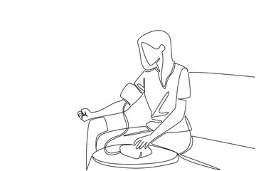 Continuous one line drawing a woman in casual clothes sitting on a sofa and measuring her blood pressure. Health conscious. Check. World Hypertension Day. Single line draw design vector illustration