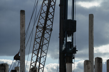 Pile driver install piles on the construction site at daytime