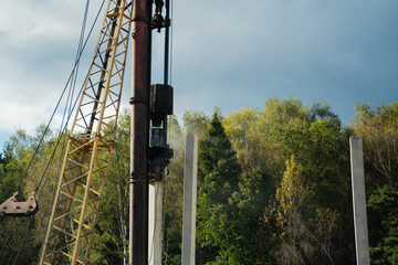 Pile driver install piles on the construction site at daytime