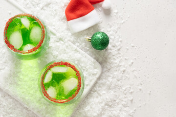 Xmas Green Punch in glass decorated sugar rim on white table make of cool lime sherbet. Tasty drink for Christmas holiday. Rim your festive beverages in red sugar. View from above.