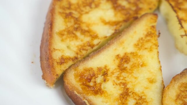 Served fried tasty toasts bread slices on plate on kitchen at home. Cook homemade domestic meal dish, hands close-up. Ingredient recipe cuisine culinary. Cooking preparing food.