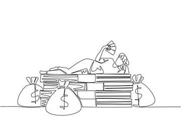 Single one line drawing a woman lying on a pile of banknotes and fanning herself with the banknotes. Multiple benefits. Investment. Be a Millionaire Day. Continuous line design graphic illustration