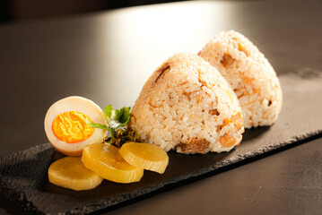 Traditional Japanese rice balls (onigiri) on wooden plate with copy space