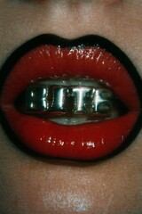 Close-up of a mouth with shiny red lipstick and silver teeth grills, BITE, Black and red Lips