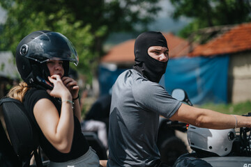 Two friends wearing protective gear riding quad bikes in a scenic countryside setting. The image portrays adventure, outdoor bonding, and safety awareness in the midst of a recreational activity.