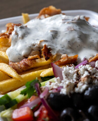 Close-up of a doner kebab plate with French fries, traditional Turkish fast food dish