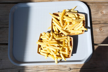 Two boxes of french fries on a tray