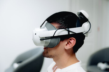 Portrait of a handsome man wearing virtual reality glasses.