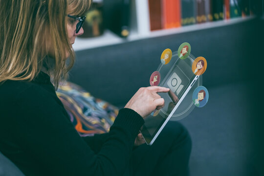 A woman enjoys a virtual meeting, video call with colleagues or friends using tablet. Modern communication and collaboration, remote work, social connection. Online remote work, social networking