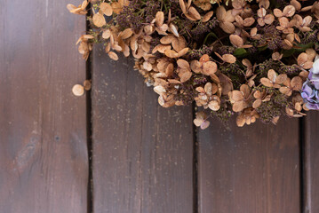 Mix of dried hydrangeas on a wooden plank background with free space for text