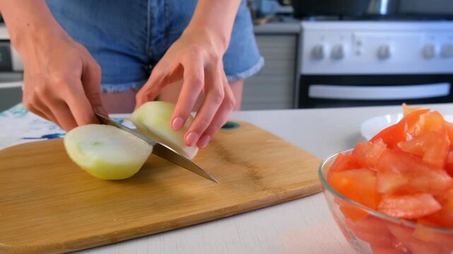 Woman chef hands cooking cutting onion on wooden board on kitchen at home. Culinary skills techniques, homemade prepare healthy meal, cook domestic food vegetable, cuisine, slicing ingredients.