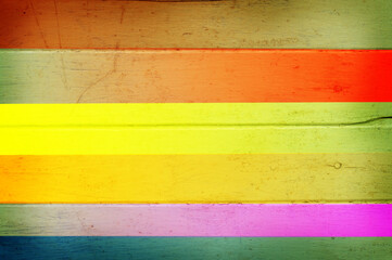 Multi color on wooden plank background.