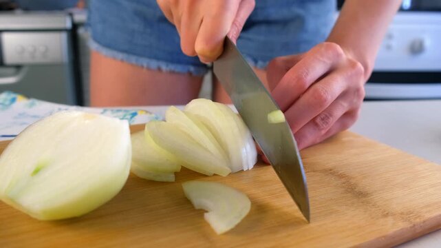 Woman chef hands cooking cutting onion on wooden board on kitchen at home. Culinary skills techniques, homemade prepare healthy meal, cook domestic food vegetable, cuisine, slicing ingredients.