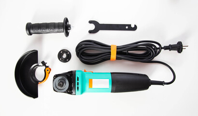 Modern set of hand-held power tools angle grinder with protective cover and additional handle on white background, industry