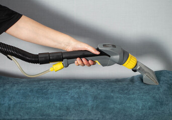 Cleaning upholstery with a vacuum attachment to remove dirt and stains effectively at home