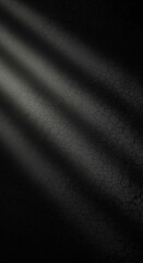 Dramatic dark background with textured cracked surface and moody light beams creating intense atmosphere for design projects