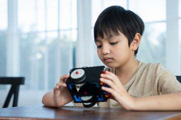 Young Engineers: multi ethnic Children engrossed in building and testing small robotics, showcasing curiosity, teamwork, and early STEM education. The focus robot and children hands-on engagement.