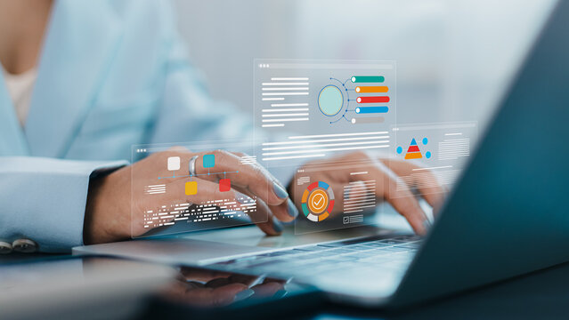 Businesswoman using laptop with data analytics dashboard and digital business report visualization
