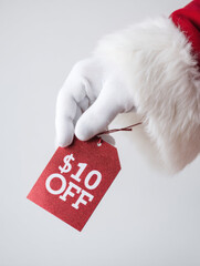 Santa Claus Hand Holding $10 Off Christmas Sale Tag