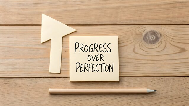 Paper arrow and note promoting progress over perfection