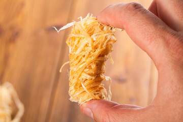 Wooden rolls for starting a fire, stove, barbecue, soaked in paraffin in hand on a wooden...