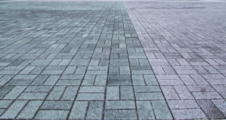 Empty grey tiled floor, pavement in perspective on modern architecture background. Abstract concrete glass building, Outdoor observation deck. street urban tile flooring. paving stones. blurred city.