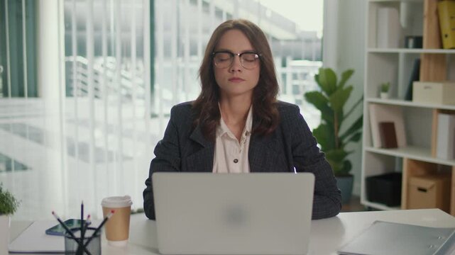 Mindful Breathing. Businesswoman Practicing Stress Relief and Relaxation at Desk, Promoting Mental Health, Focus, and Employee Wellbeing in the Modern Workplace