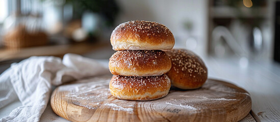 Freshly baked buns stacked on board in kitchen