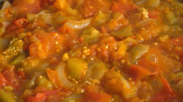 Vegetables stew cooking in frying pan on kitchen close up view. Culinary techniques, homemade preparing healthy meal vegetarian cook food dish, cuisine, seasoning garlic. Healthy vegan domestic food.