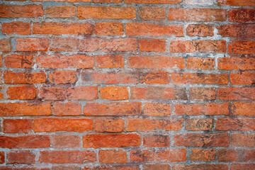 Rustic brick wall background tetxture in different shades of red and orange. Old red brick wall background texture close up. Background for designs or 3d texture.