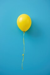 Bright Yellow Balloon with String Light Blue Background