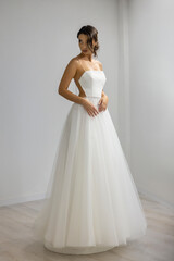 Stylish bride in elegant A-line gown with delicate straps, modern and graceful bridal portrait