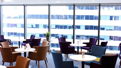 Modern Business Lounge with Cityscape View Through Windows.