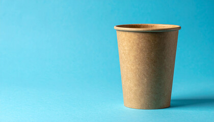 Minimalist eco-friendly craft paper cup, recyclable disposable tableware, blue background