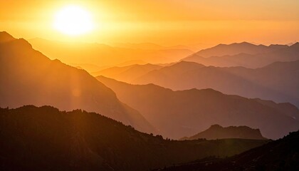 Fototapeta premium Golden Sunrise Over Mountain Range with Warm Hues and Layers of Peaks in Silhouette Under Bright Sunlight in a Scenic Landscape Panorama