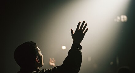 Close of hand raised in faith, worship, and praise to God during a Christ-centered service